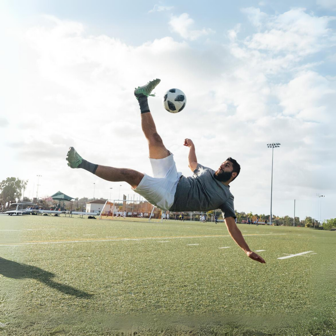 a man kicking a football ball