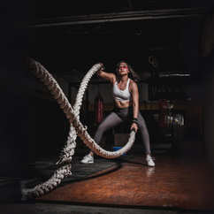 a woman holding a rope in gym